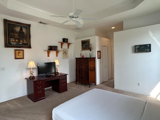 carpeted bedroom featuring ceiling fan and a raised ceiling