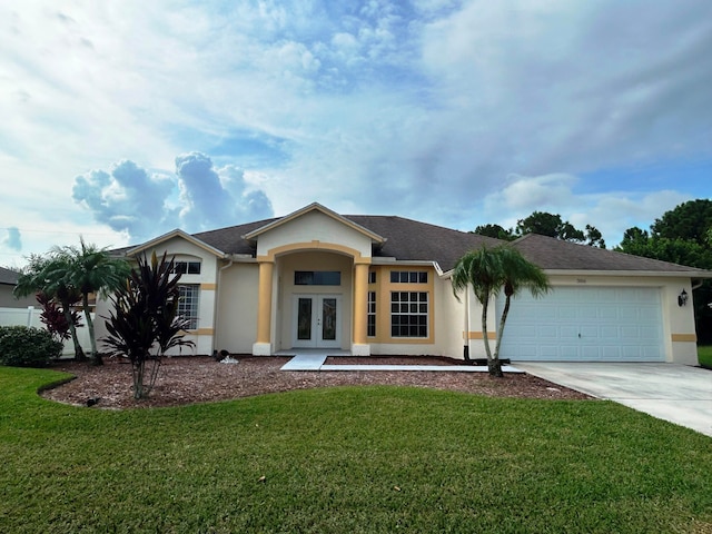 ranch-style house with a garage, french doors, and a front yard