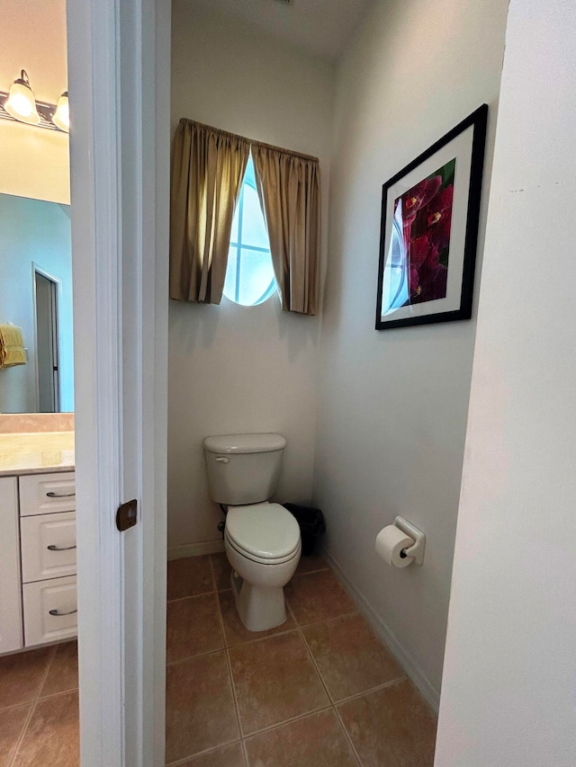 bathroom featuring tile patterned floors, vanity, and toilet