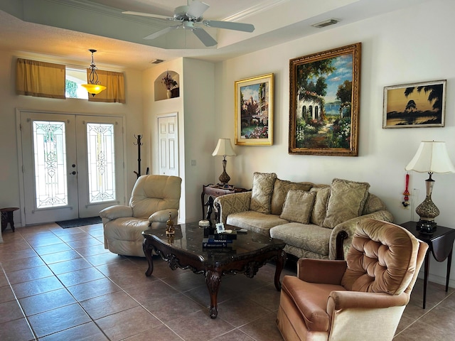 tiled living room featuring ceiling fan and french doors