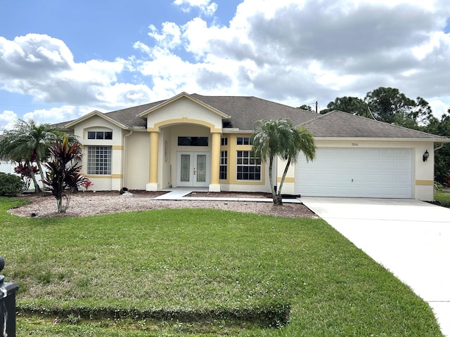 single story home with an attached garage, driveway, french doors, stucco siding, and a front lawn