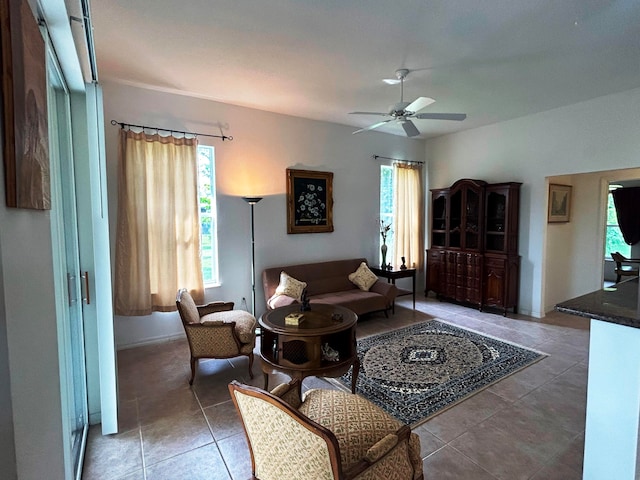 tiled living room with ceiling fan and plenty of natural light