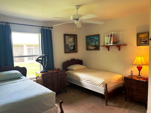 bedroom featuring a textured ceiling, carpet floors, and ceiling fan