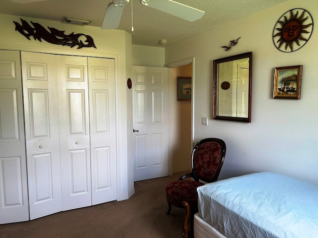 carpeted bedroom featuring ceiling fan and a closet