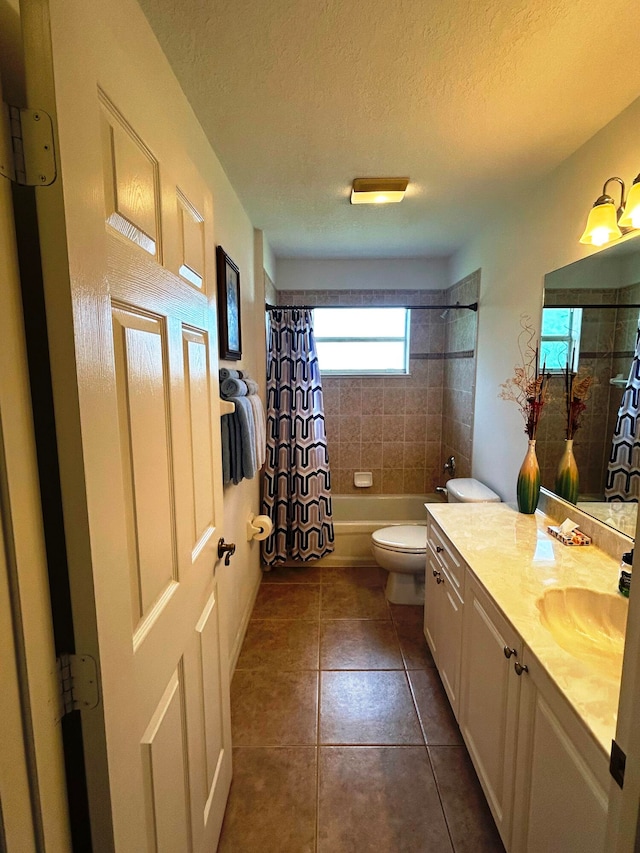 full bathroom featuring toilet, vanity, tile patterned floors, a textured ceiling, and shower / bath combination with curtain