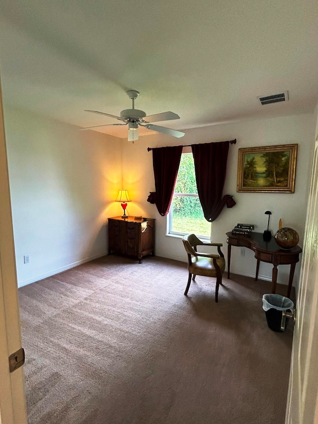 sitting room featuring ceiling fan and carpet