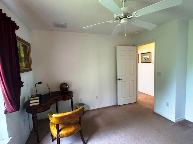 living area featuring ceiling fan and carpet