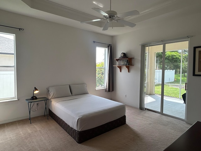 bedroom featuring carpet floors, ceiling fan, and multiple windows