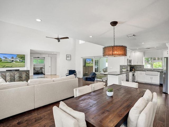 dining room featuring sink, ceiling fan, and dark hardwood / wood-style flooring