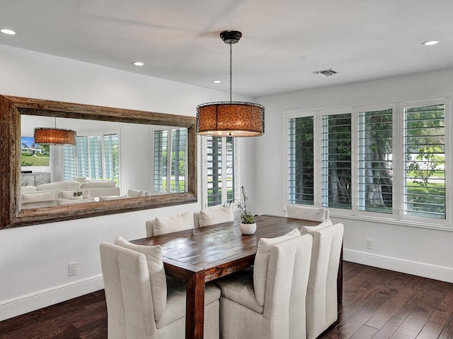 dining room with plenty of natural light and dark hardwood / wood-style floors