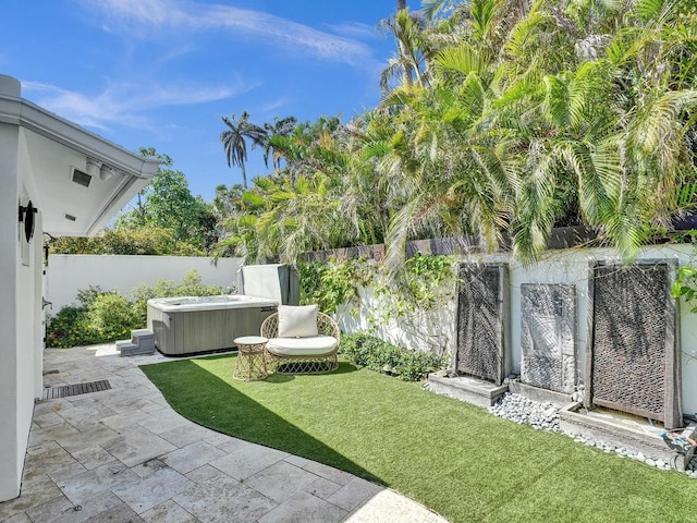 view of yard with a patio and a hot tub