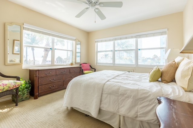 bedroom featuring ceiling fan and light carpet