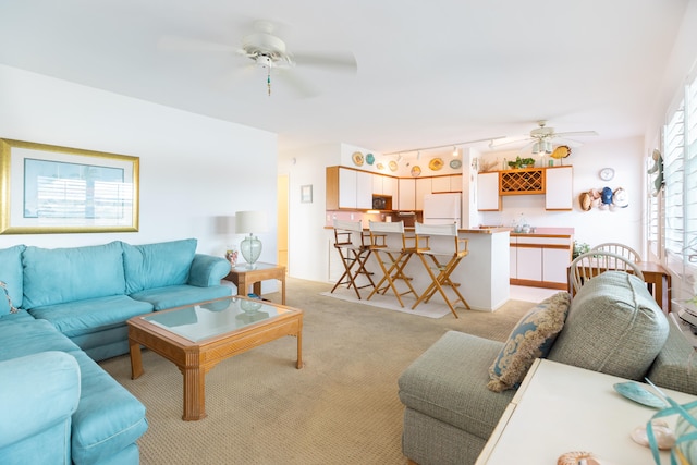 living room featuring light carpet and ceiling fan