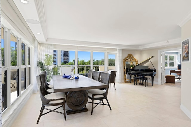 interior space featuring crown molding, a tray ceiling, and a wealth of natural light