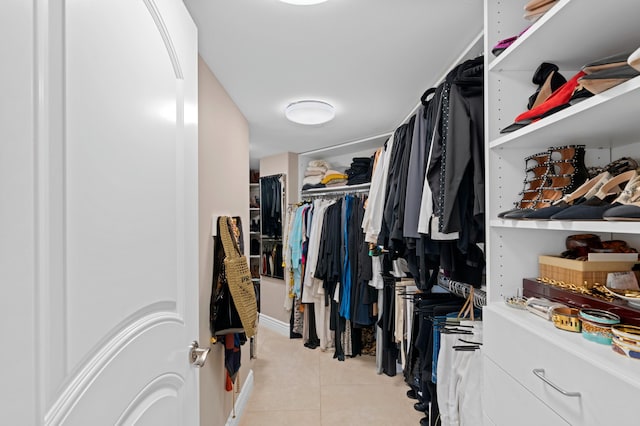 walk in closet featuring light tile flooring