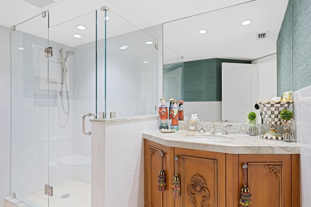 bathroom with an enclosed shower and vanity