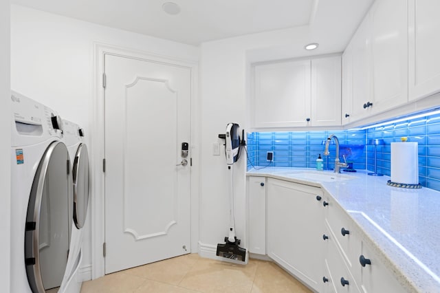 laundry area featuring sink, independent washer and dryer, cabinets, and light tile floors