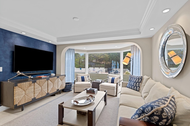 living room featuring ornamental molding and a tray ceiling