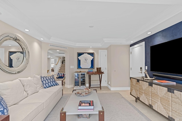 living room featuring a tray ceiling and light tile floors