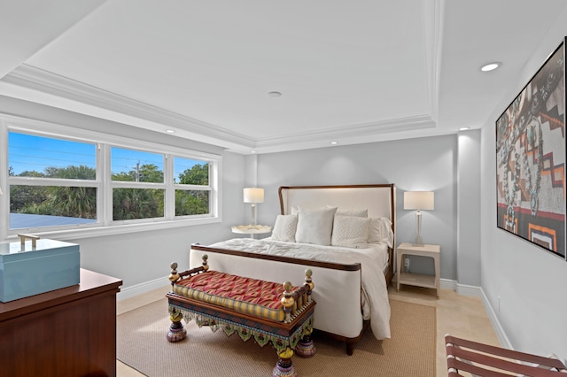 bedroom with light tile floors and a tray ceiling