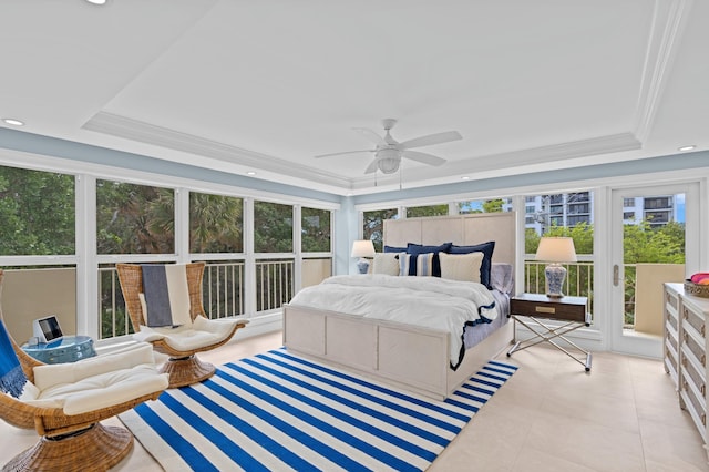 tiled bedroom featuring multiple windows, ceiling fan, and a tray ceiling