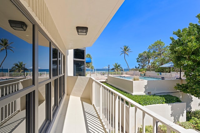 balcony with a fenced in pool