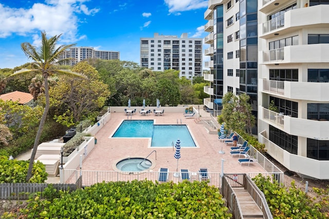 view of swimming pool featuring a hot tub