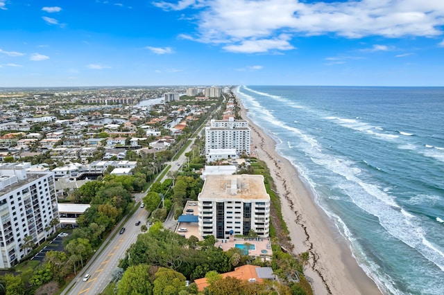 aerial view with a water view and a beach view