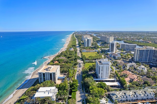 birds eye view of property with a beach view and a water view