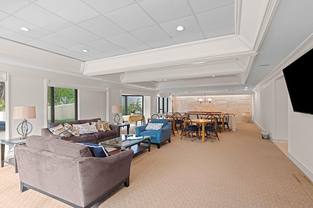 carpeted living room featuring a chandelier, a tray ceiling, and crown molding