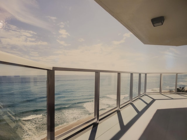 balcony with a view of the beach and a water view