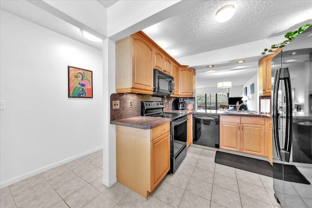 kitchen with tasteful backsplash, a textured ceiling, light tile floors, and black appliances