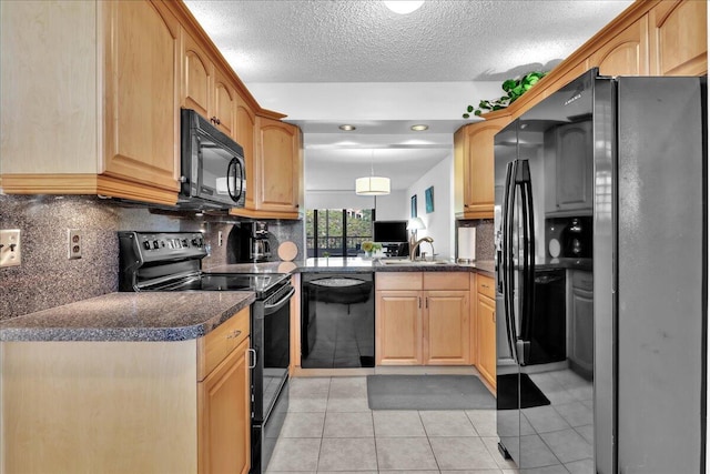 kitchen featuring light tile flooring, kitchen peninsula, tasteful backsplash, black appliances, and hanging light fixtures