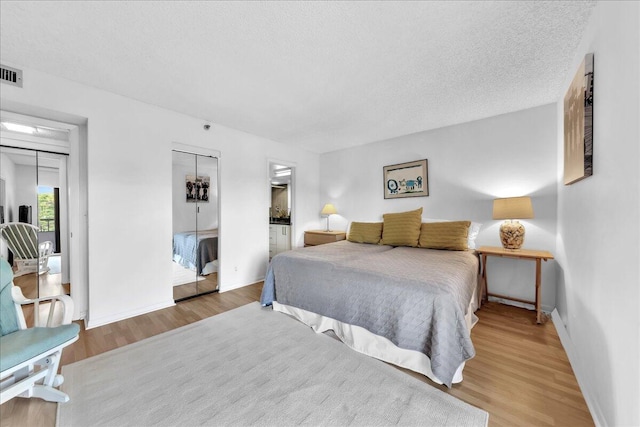 bedroom featuring a closet, light hardwood / wood-style flooring, and a textured ceiling