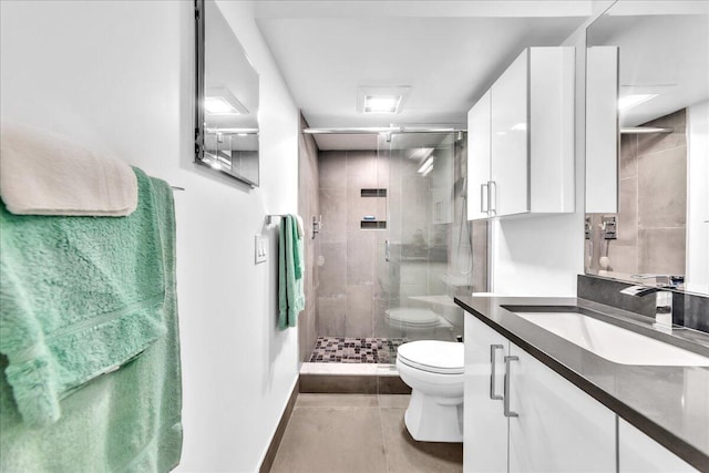 bathroom featuring toilet, tile floors, a shower with shower door, and oversized vanity