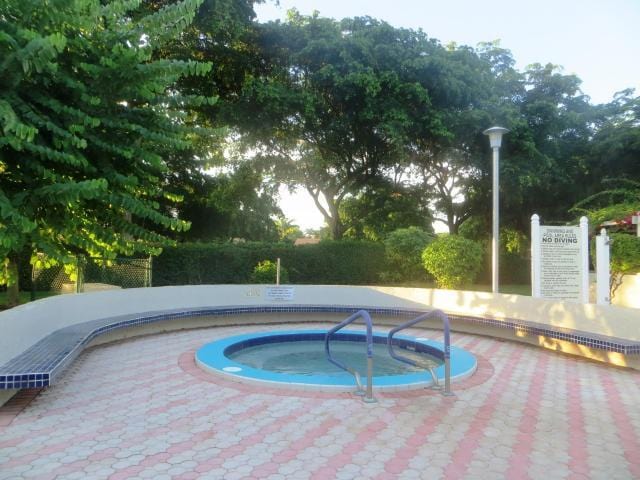 view of pool with a community hot tub