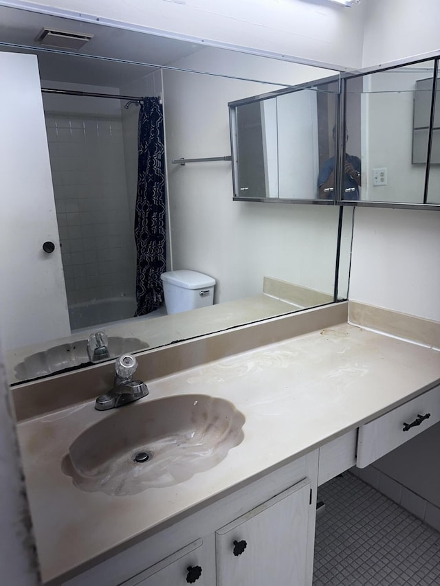 full bathroom with shower / bath combination with curtain, toilet, vanity, and tile patterned flooring