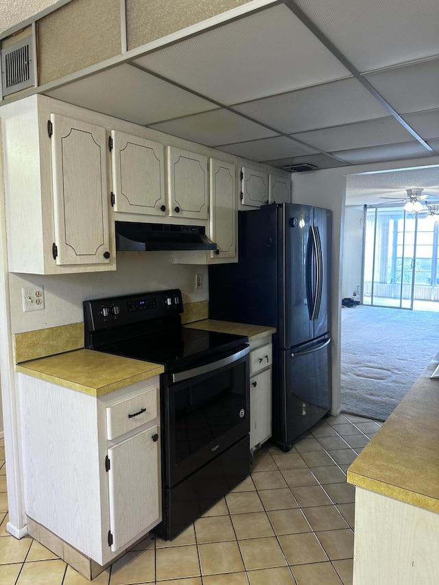 kitchen featuring black appliances, light colored carpet, a drop ceiling, and ceiling fan