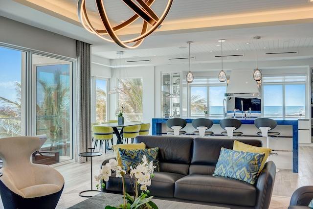 living room featuring a water view and light hardwood / wood-style floors