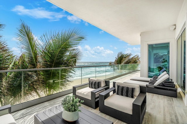 balcony with an outdoor living space and a water view