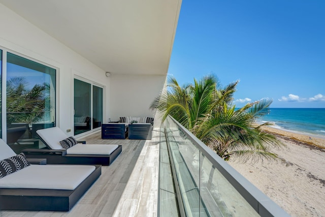 balcony with a beach view and a water view