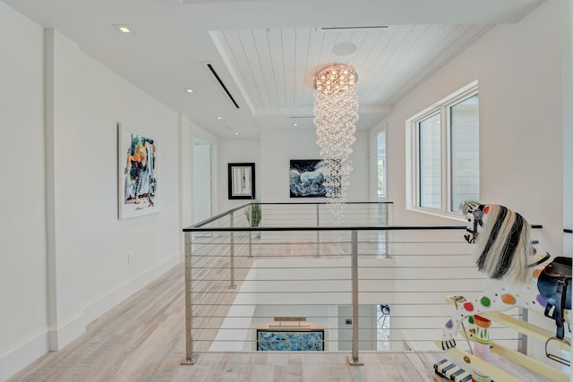 interior space featuring wood-type flooring and an inviting chandelier