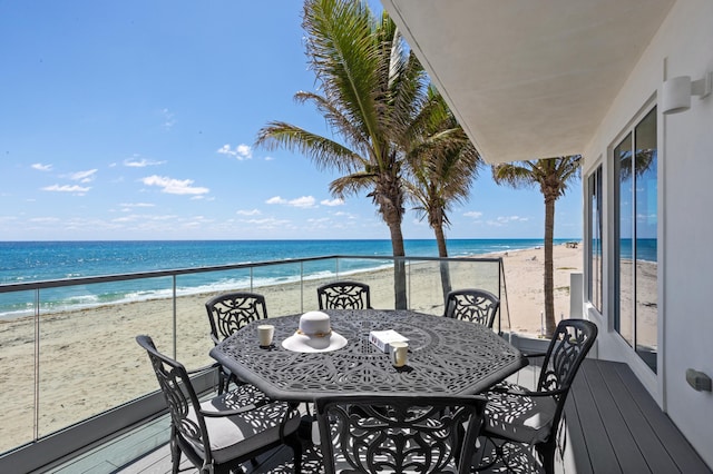 balcony with a beach view and a water view