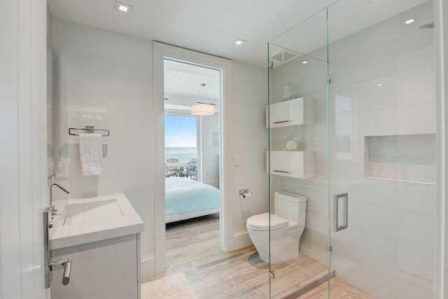 bathroom with hardwood / wood-style flooring, toilet, and vanity