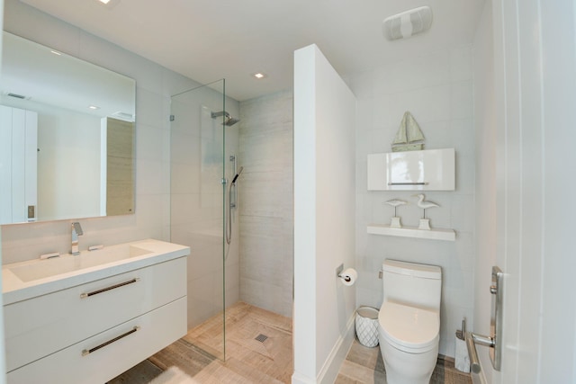 bathroom featuring an enclosed shower, vanity, and toilet