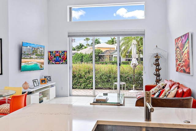 tiled living room featuring a high ceiling