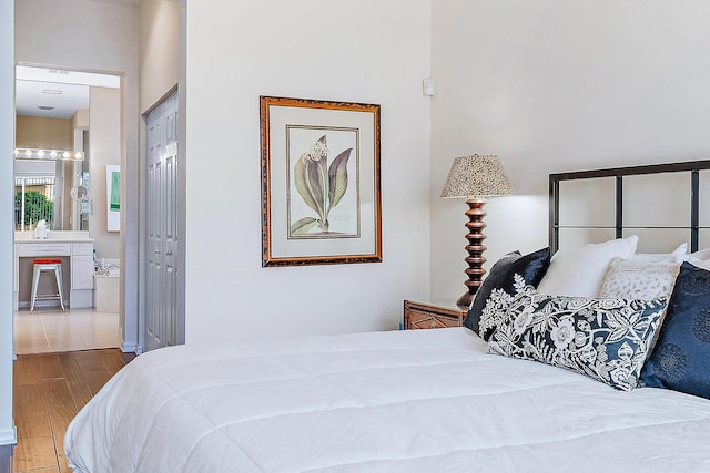 bedroom with a closet and light hardwood / wood-style floors