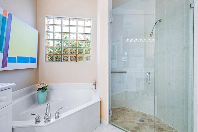 bathroom featuring vanity, plus walk in shower, and tile flooring