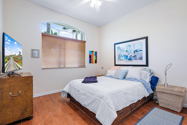 bedroom with dark hardwood / wood-style floors and ceiling fan