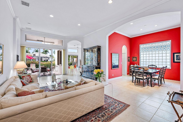 living room featuring light tile floors and crown molding